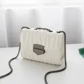 Elegant white quilted chain crossbody bag with silver lock and wavy stitched texture - White (Gunmetal Hardware)