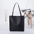 Classic black PU leather tote bag featuring elegant tassels and long shoulder straps - Black