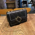 Women's black shoulder bag with white contrast stitching and golden chain strap - Black