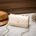 Beige quilted small square shoulder bag with golden chain and metal twist lock detail - White
