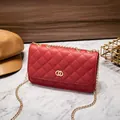 Red quilted shoulder bag with gold chain strap and interlocking metal ring clasp - Red