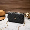 Quilted black leather crossbody bag with gold chain strap and double ring clasp - Black