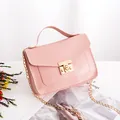 Pink faux leather crossbody bag with lizard texture and gold chain strap - Pink
