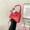 Red crocodile embossed leather handbag with silk scarf and gold logo branding - Red