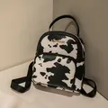 Chic mini backpack for women featuring stylish cow print pattern and gold hardware - Cow Print