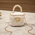 White quilted mini jelly bag featuring a pearl top handle and golden heart lock - White