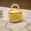 Yellow quilted jelly handbag with pearl handle and golden double heart logo - Yellow