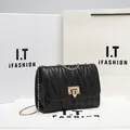 Black quilted chain crossbody bag featuring gold twist lock and elegant wave texture - Black