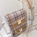 Classic plaid chain shoulder bag with gold twist lock on a reflective mirror base - Khaki