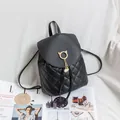 Black quilted backpack for women featuring cat-ear hardware and pearl tassel detail - Black