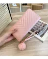 Detail of pink long wallet with V-quilted pattern and a soft faux fur pompom keychain - R007 Pink