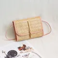 Straw woven crossbody bag with pink leather trim and gold tassel detailing - Pink
