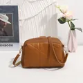 Brown quilted crossbody bag with triangular embroidery and gold hardware detail - Brown