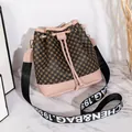 Pink drawstring bucket bag featuring circle pattern and woven JICHEN shoulder strap - Pink