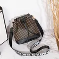 Retro geometric bucket bag in brown and black with a branded lettering shoulder strap - Black