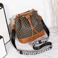 Retro bucket bag with geometric canvas patterns and a wide designer shoulder strap - Brown