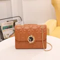 Caramel star quilted crossbody bag with golden chain strap and round pearl lock detail - Brown