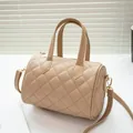Elegant beige quilted bowling handbag with top handles and adjustable shoulder strap - Khaki