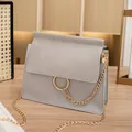 Light grey crossbody bag with gold ring and chain strap in sleek faux leather finish - Gray