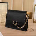 Minimalist black crossbody bag with gold ring detail and elegant chain strap for women - Black