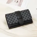 Women's black faux leather mini wallet featuring floral patterns and secure strap closure - Black