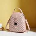 Pink mini backpack for women featuring cat pendant and brown circular floral patterns - Pink