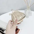 Mini shell-shaped golden lip bag with chain strap and shiny metallic finish - Scallop Gold