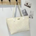 White tote bag with yellow circular totem pattern and a central golden metal logo plate - White
