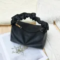 Black lychee texture crossbody bag with stylish pleated handle and gold hardware detail - Black