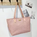 Elegant pink tote bag with brown geometric logo patterns and a gold metal logo plate - Pink