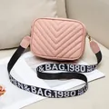 Pink quilted crossbody bag with stylish V-stitch pattern and wide lettered strap - Pink