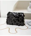 Close-up of shimmering black sequins and gold chain strap on a stylish crossbody bag - Black