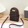 Dark brown PVC crossbody phone bag with SAKM logo print and adjustable burgundy strap - Coffee