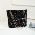 Fashionable black sequin shoulder bag with golden chain strap and shiny finish - Black