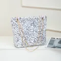 Chic silver sequin shoulder bag with golden chain straps and minimalist tote silhouette - White