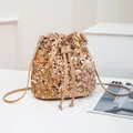 Sparkling champagne gold sequin bucket bag with drawstring closure and leather strap - Gold