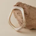 Macro detail of irregular wave acrylic bangle featuring vintage marble textures - Creamy White Marble Wave Style (AB0026-4)