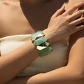 Detail of chunky green resin and polished gold metal links on a female wrist - Light Green Polyhedron Splicing (AB0038-4)