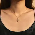 Golden sun-flower shell pendant necklace in stainless steel on a model's collarbone - Metal Shell Style (SN0016)