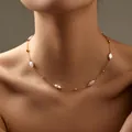 Elegant 18K gold plated necklace with delicate oval white pearls on model collarbone - Oval Pearl Necklace (KN0375)