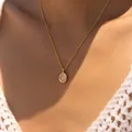 Close-up of 18K gold-plated necklace with oval tiger eye stone on female model - Light Pink Oval Gemstone Style (KN0611-4)