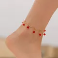 Golden spiral anklet with dark red faceted crystal charms shown on ankle - Red Faceted Crystal Bead Style (KA0303-2)