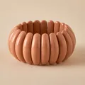 Close-up of wide caramel resin stretch bracelet with smooth oval macaron style beads - Oval Module Style (AB0067-3) / Caramel Brown