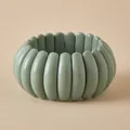 Detail of gray-green chunky resin beaded bracelet with smooth matte finish elastic band - Cylindrical Bead Style (AB0067-2) / Grey Green