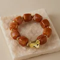 Detailed macro view of amber marble resin square beads and gold irregular charm bracelet - Deep Amber Marble Pattern (AB0075-6)