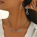 Detail of silver horsebit necklace and earrings on model with polished metallic finish - Horsebit Necklace Earrings Set (XL5911-2) / Silver