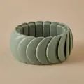 Macro shot of bean green matte resin bracelet showing flexible elastic band and tiered beads - Layered Tile Style (AB0069-2)