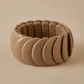Detailed top view of a chunky khaki elasticated resin bracelet on a warm beige backdrop - Overlapping Petal Style (AB0069-3)