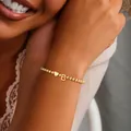 Detail of gold beaded bracelet with heart and letter B charms worn on a wrist - Letter B (SF1019-B)
