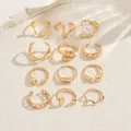 Flat lay of 12-piece gold geometric ring set including pearl and lava style designs - Geometric Artificial Pearl Ring 12-Piece Set (JZ1461) / Gold